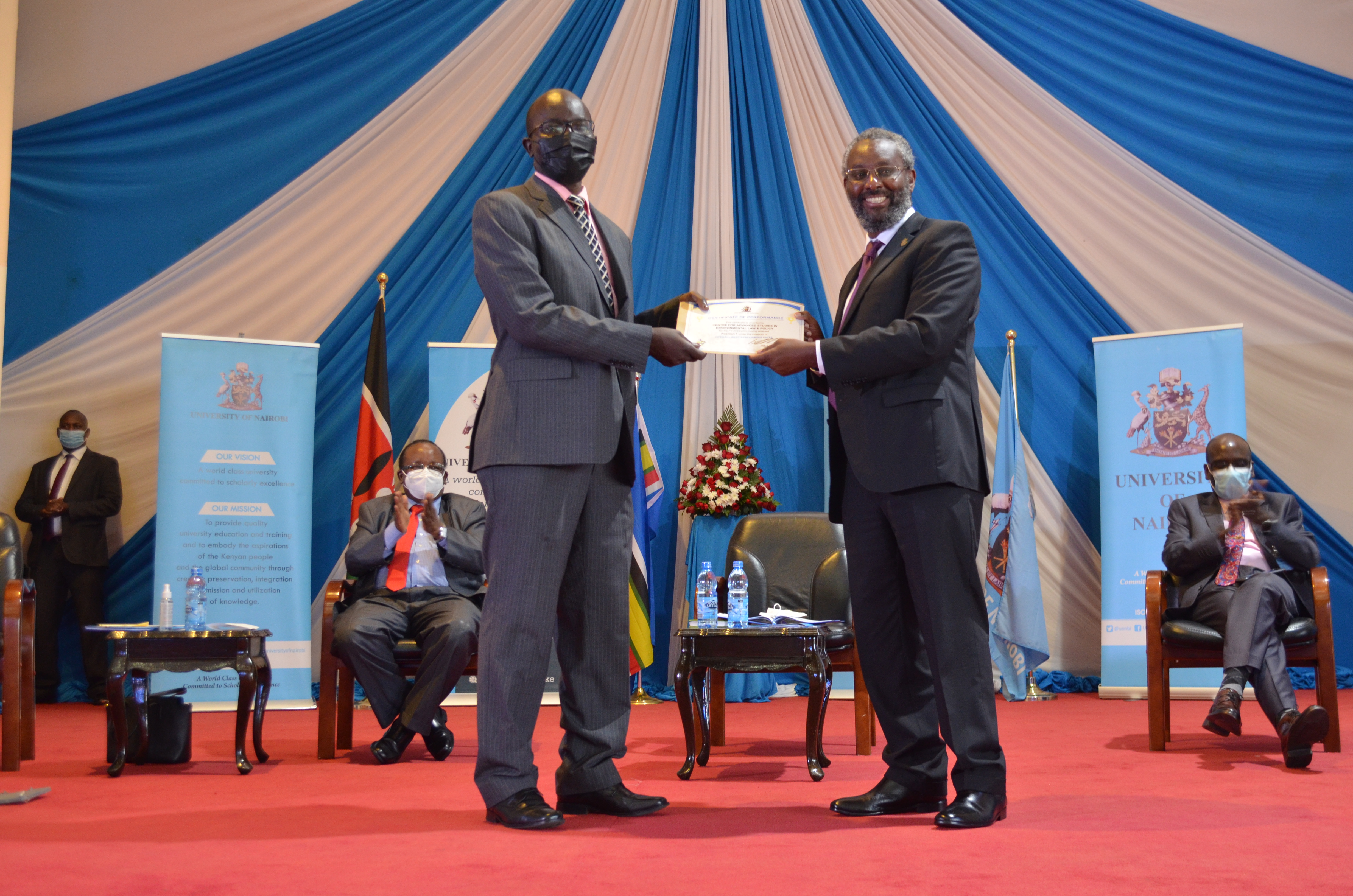 Dr. Collins Odote, CASELAP receives a certificate from UoN VC Prof. Kiama