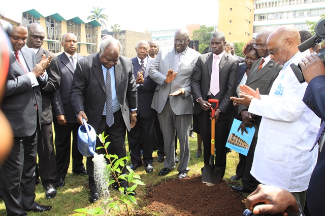 Retired President H.E. Mwai Kibaki plants a commemorative tree at Main Campus after giving a public lecture at Taifa Hall. VC Magoha (Clapping) 2013