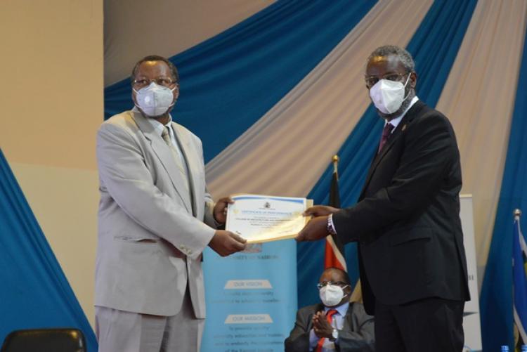 Prof. Rukwaro picking an award on behalf of CAE at the PC awards ceremony 