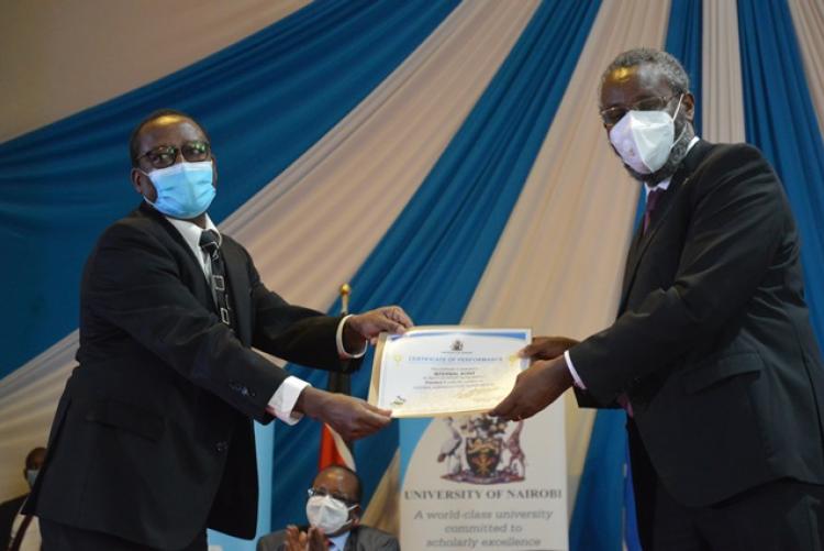 Chief Internal Auditor, Mr Gitau picking an award at the PC Award ceremony