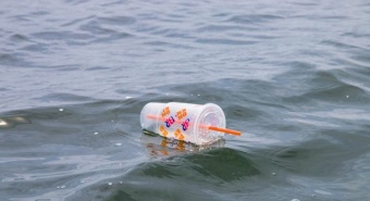 Plastic container floating in a water body