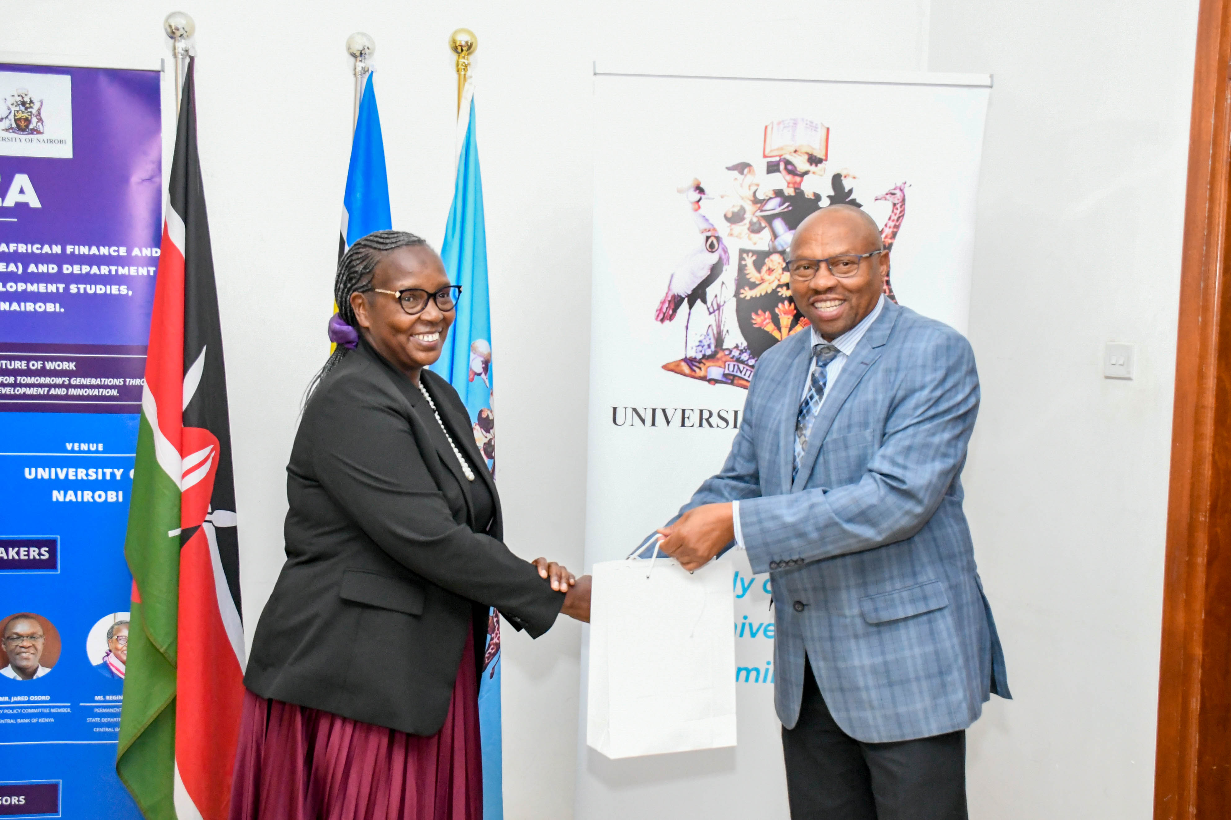 DVC, FPD Prof Jackson Maalu, representing the VC, gifts the PS for Trade Ms Regina Ombam during the opening ceremony.