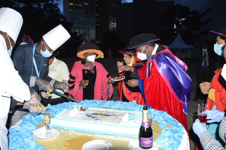 Management cuts cake at the UoN at 50 celebrations 