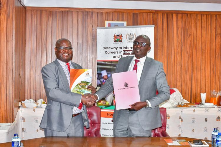 The DVC, Prof Josiah Aduda and Kenya Utalii College Principal/CEO Mr. Mark Ogendi exchange the signed MoU following the official signing ceremony.