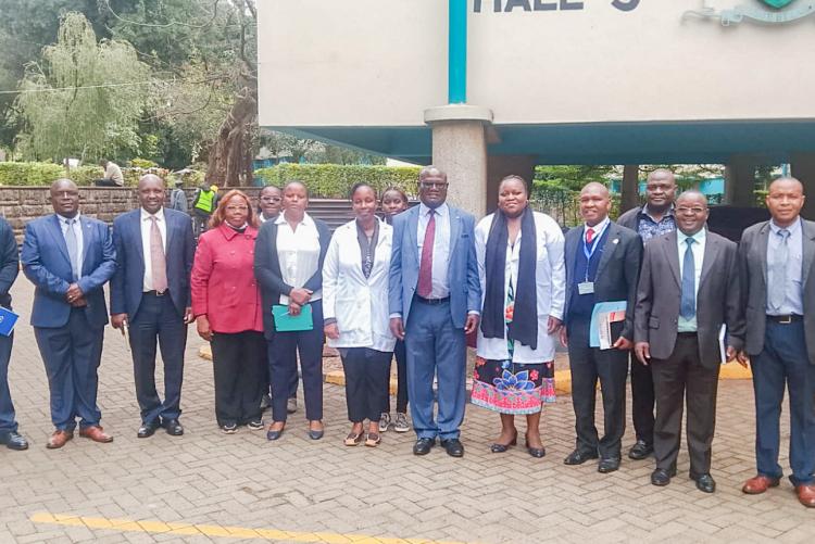 Deputy Vice-Chancellor for Finance, Planning and Development, Prof. Josiah Aduda, poses for a group photo with University Health Services staff during his familiarization tour of the facility.