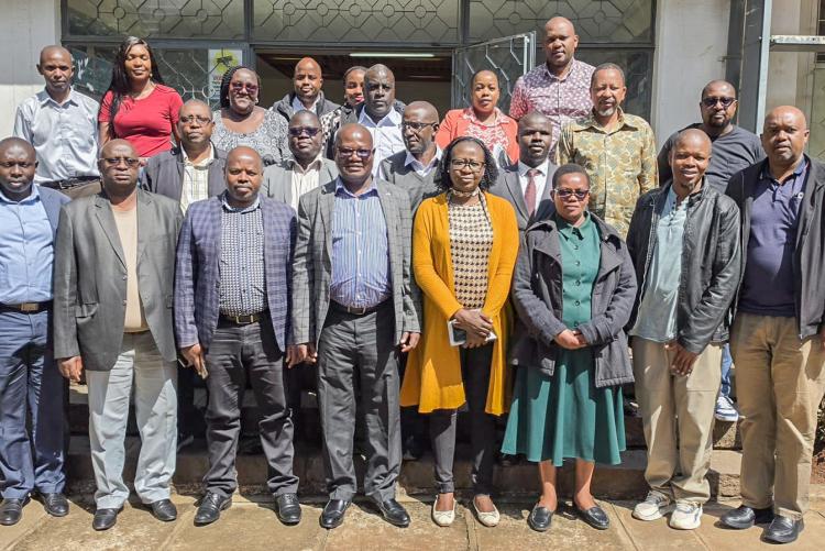 Deputy Vice-Chancellor for Finance, Planning and Development, Prof. Josiah Aduda, poses for a group photo with members of staff from the ICT Department following a courtesy call and engagement session