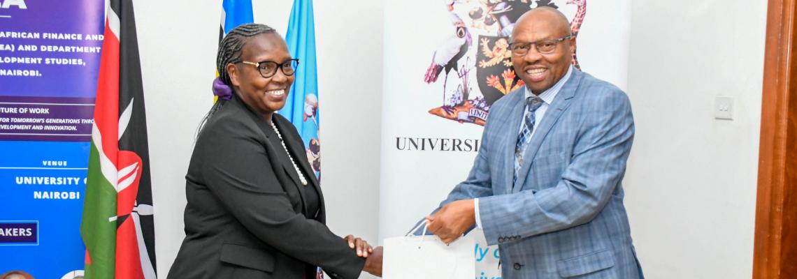 DVC, FPD Prof Jackson Maalu, representing the VC, gifts the PS for Trade Ms Regina Ombam during the opening ceremony.
