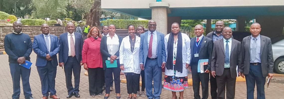 Deputy Vice-Chancellor for Finance, Planning and Development, Prof. Josiah Aduda, poses for a group photo with University Health Services staff during his familiarization tour of the facility.
