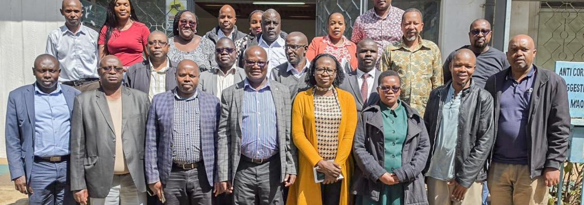 The DVC for Finance, Planning and Development, Prof. Josiah Aduda, poses for a group photo with members of staff from the ICT Department following a courtesy call and engagement session